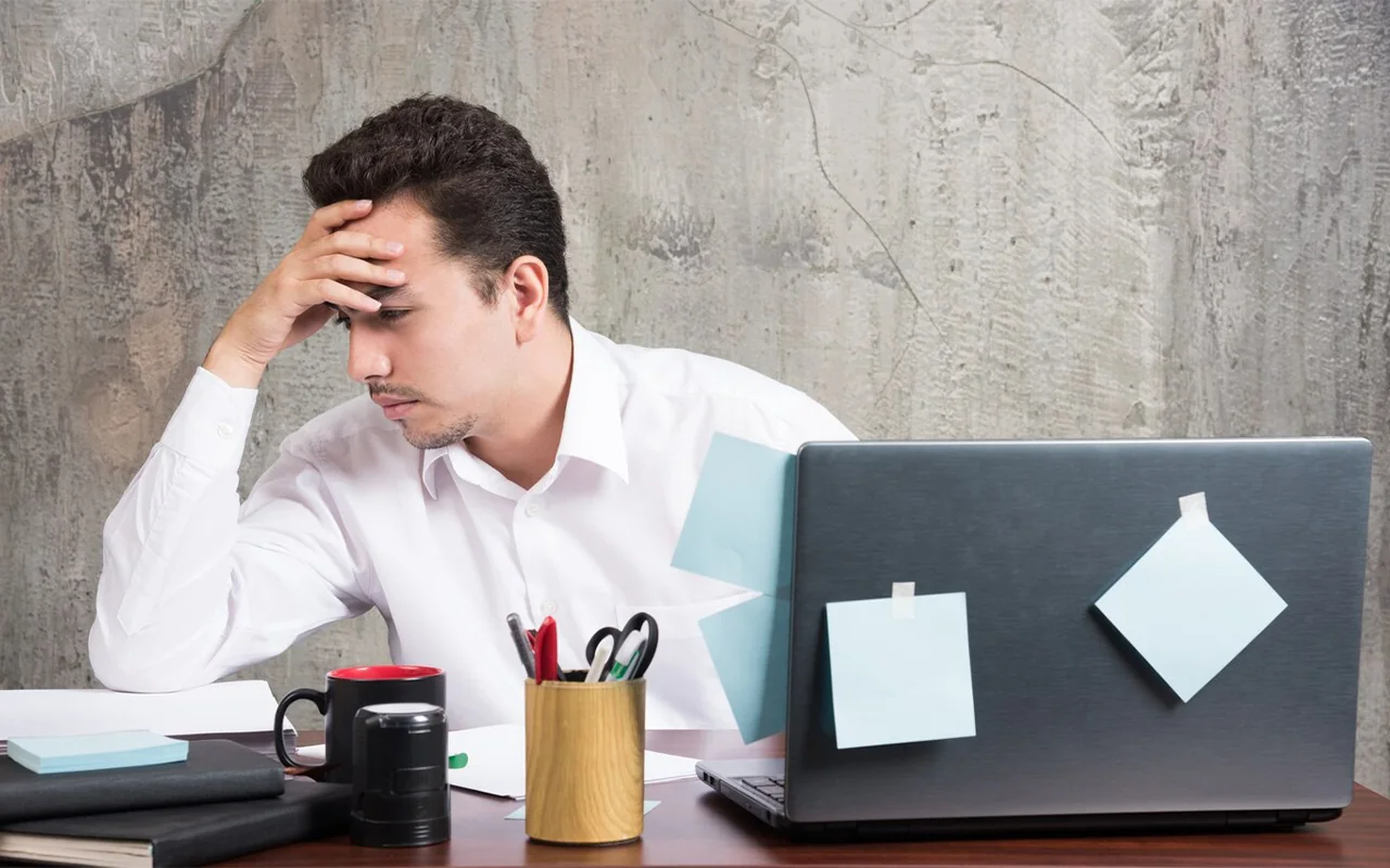 Man considering a work problem at his desk