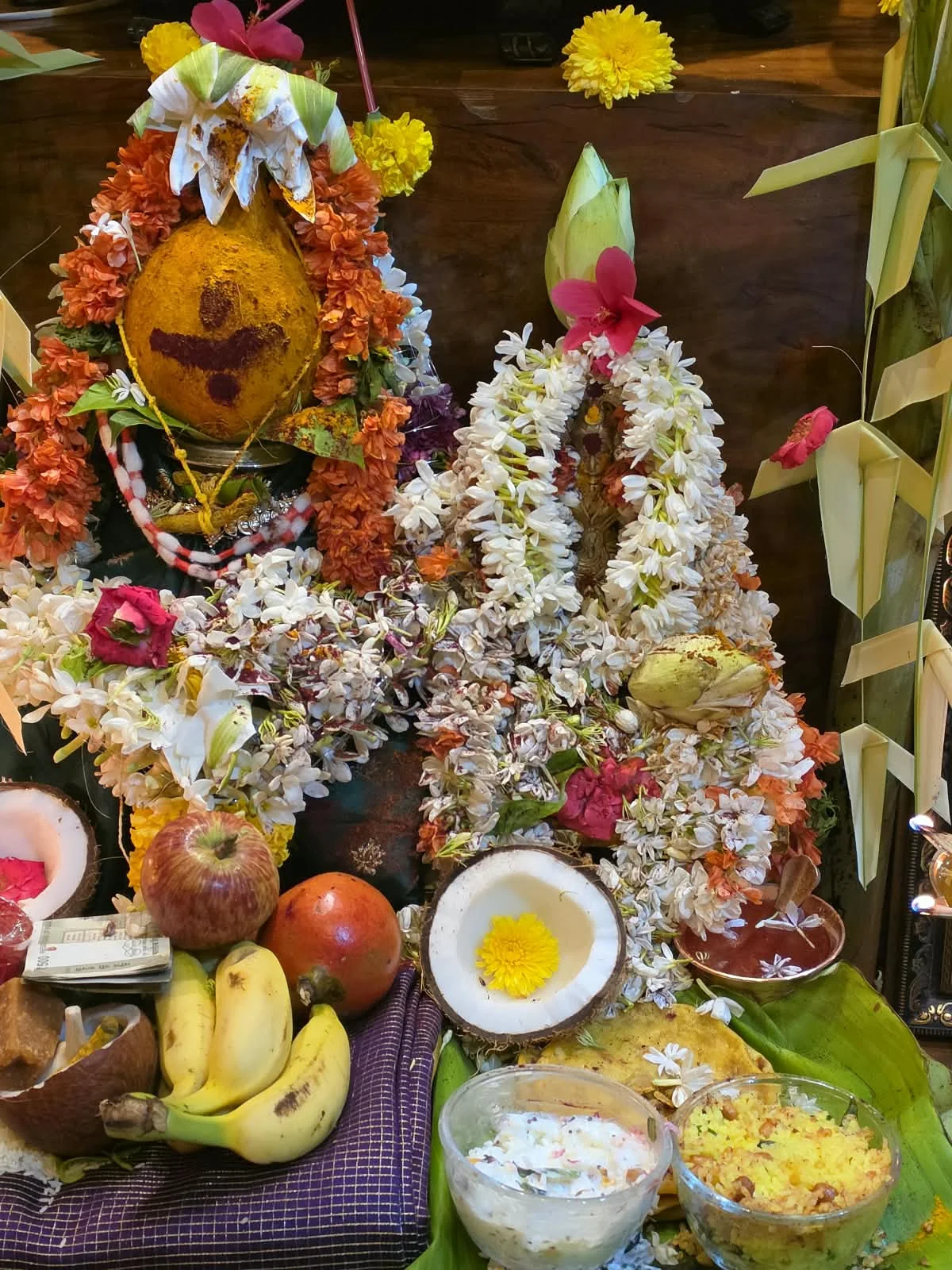 Traditional puja offerings with flowers, decorated coconuts and fruit Traditional puja offerings with flowers, decorated coconuts and fruit