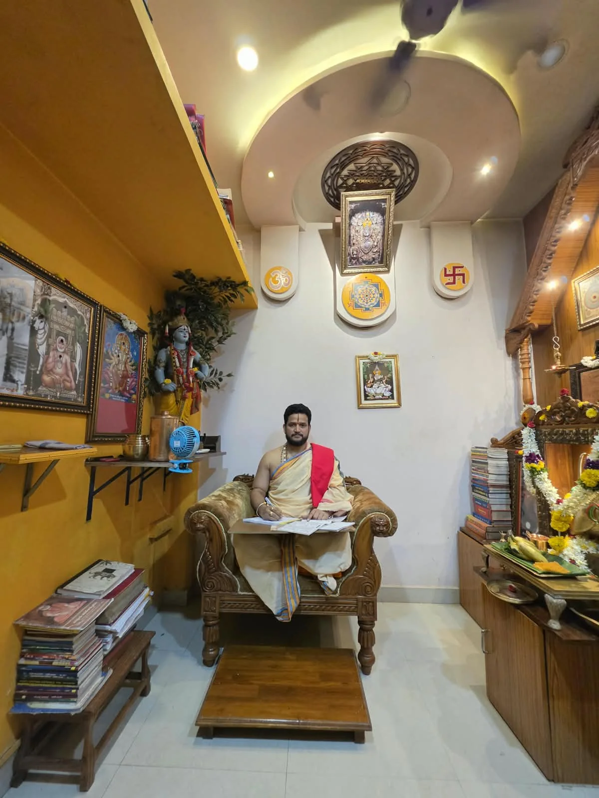 Pandit Hampi Ravishankar Shastri seated at his consultation desk in Vijayawada